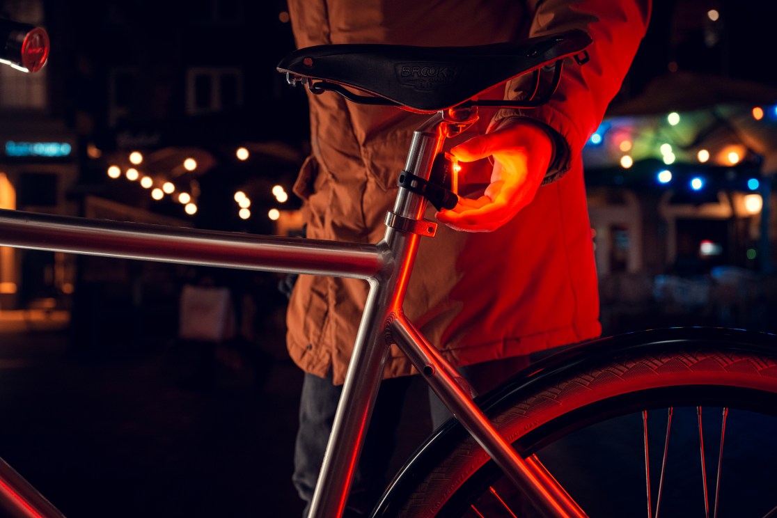 AXA Bike Security Dwn USB rear light on a saddle pin, life style image